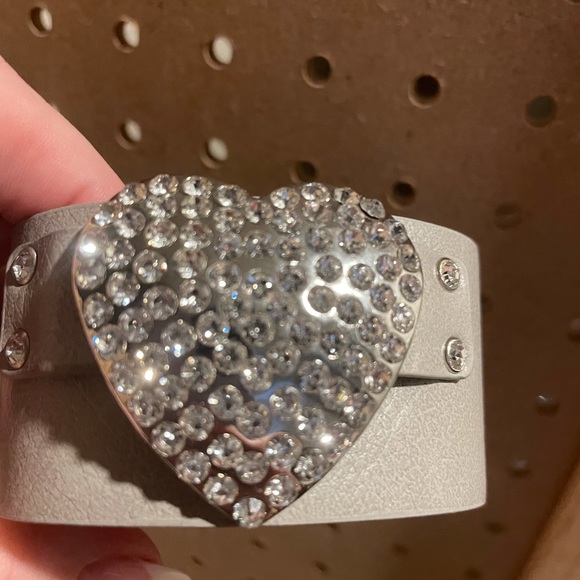 Light gray faux leather cuff with rhinestone heart.